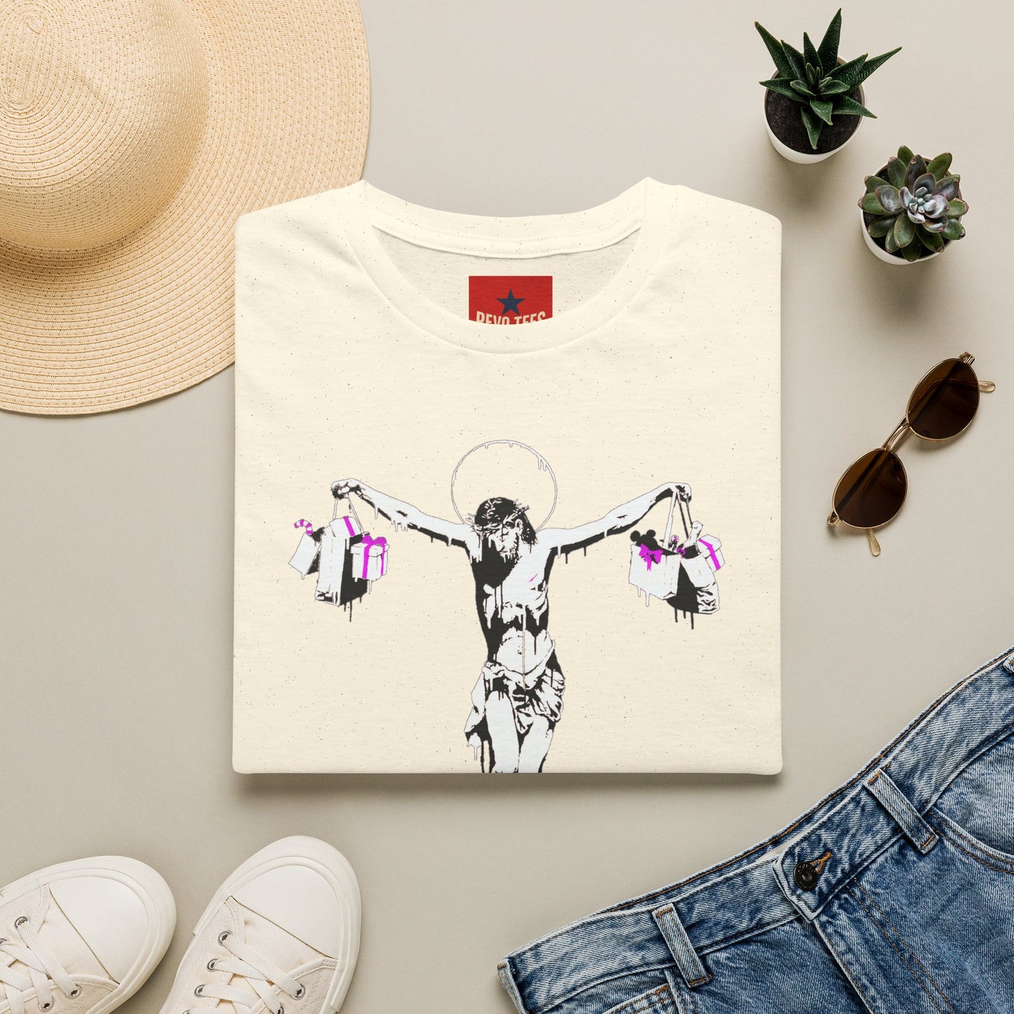 Banksy Crucifixion Balance Tee — Stenciled Jesus Holding Gift Bags Graphic T-Shirt