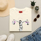 Banksy Crucifixion Balance Tee — Stenciled Jesus Holding Gift Bags Graphic T-Shirt