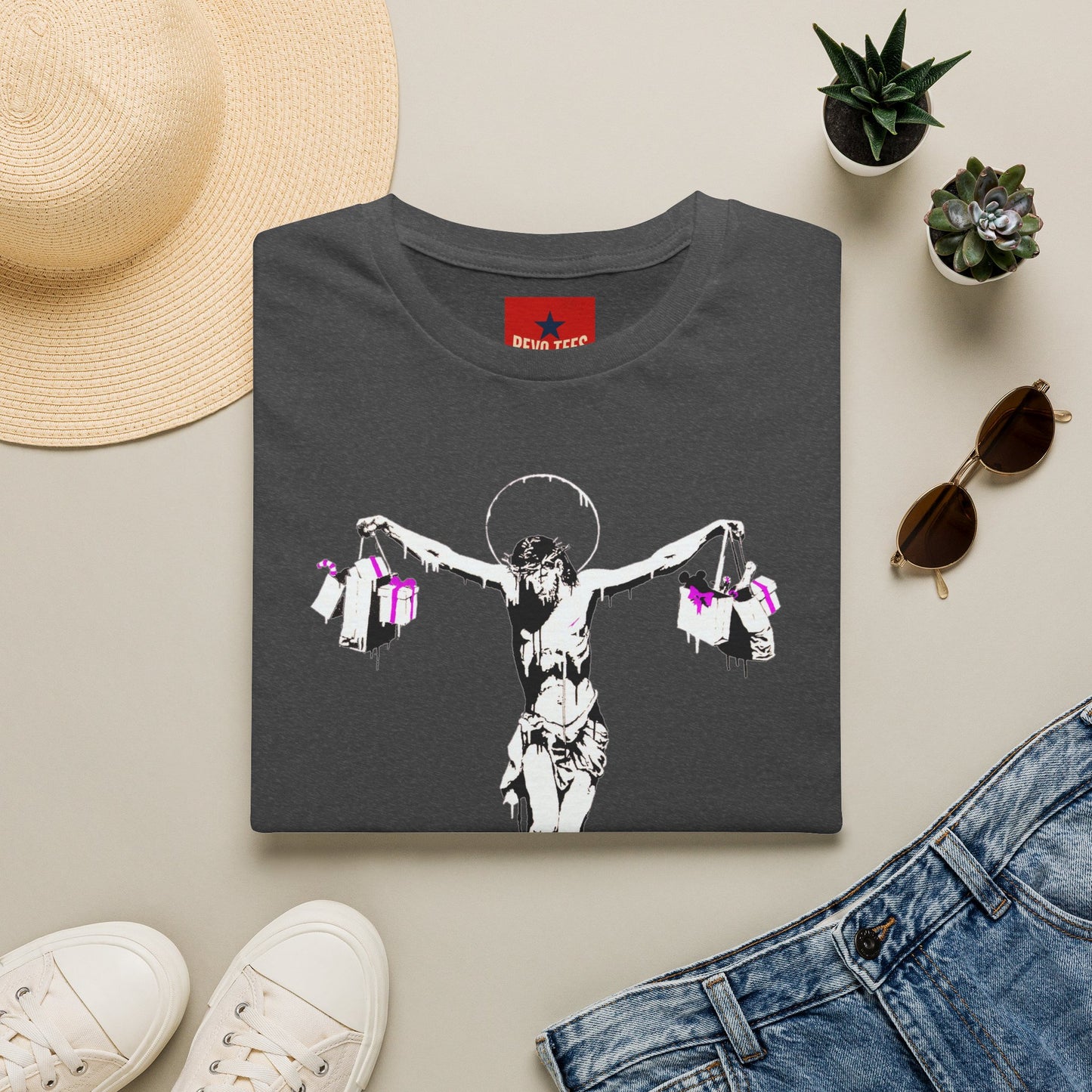 Banksy Crucifixion Balance Tee — Stenciled Jesus Holding Gift Bags Graphic T-Shirt