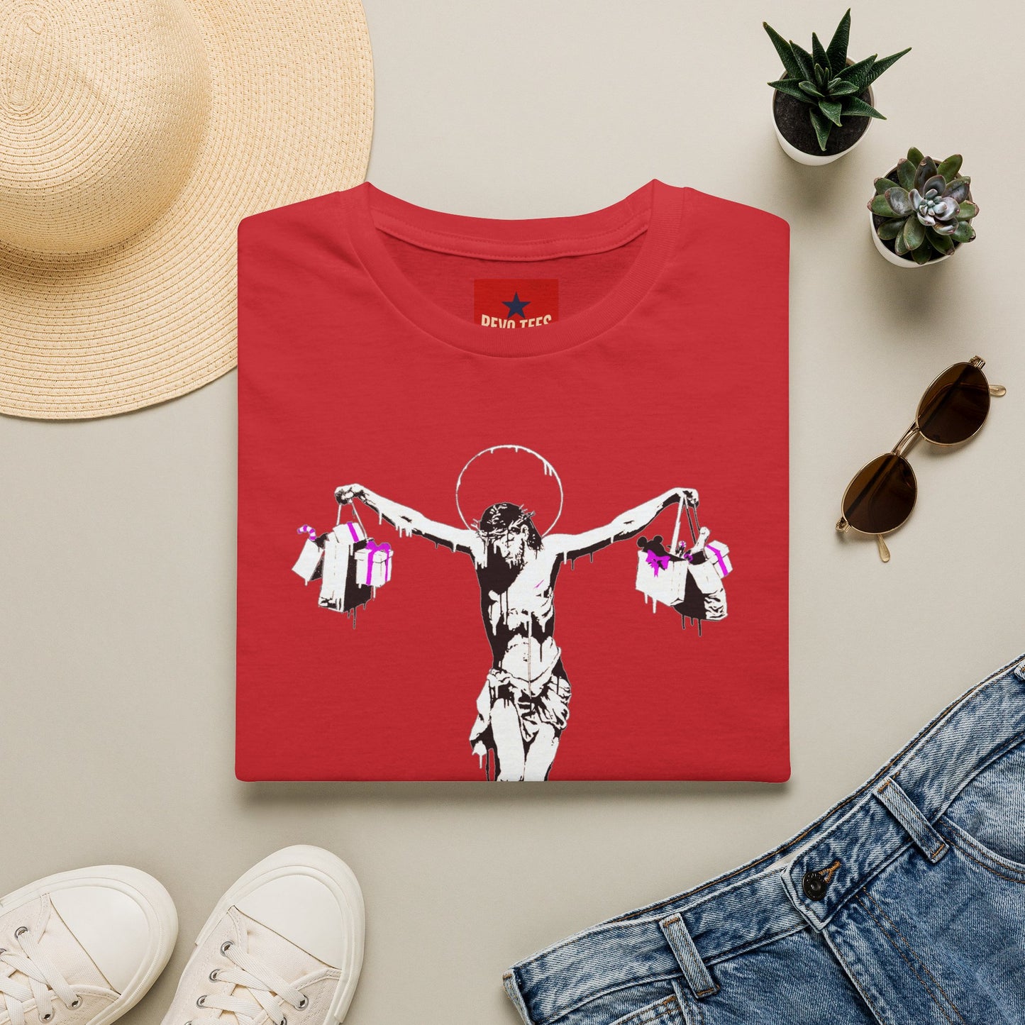 Banksy Crucifixion Balance Tee — Stenciled Jesus Holding Gift Bags Graphic T-Shirt